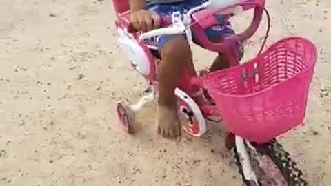 The boy learns to ride bicycle.