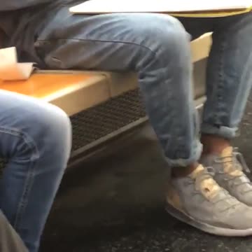 A man draws a sketch on subway train