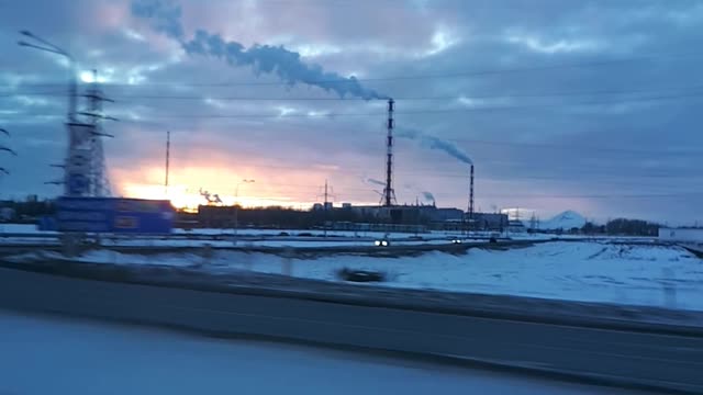 Sunset on the background of the chimneys of the plant.