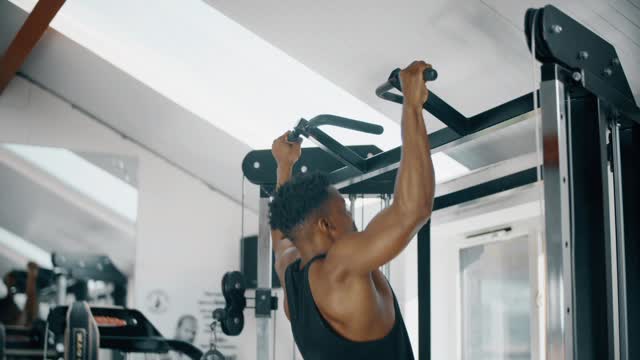 Man Doing Pull Ups in Gym