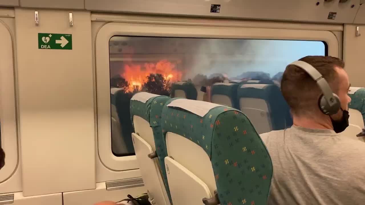 - A train was surrounded by wildfires in western Spain today.