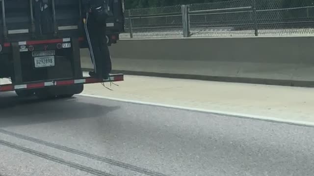 Man Hitches a Ride on a Semi