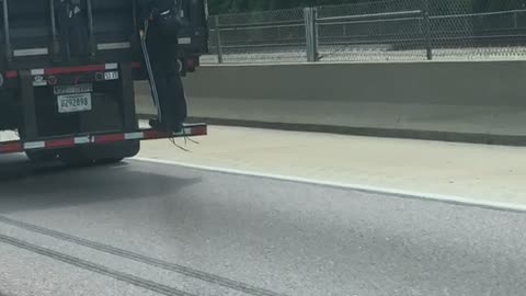 Man Hitches a Ride on a Semi