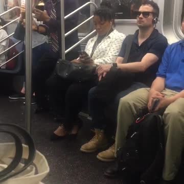 Sunglasses and tie guy dances in subway