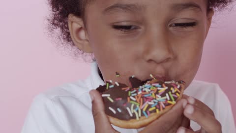 A Boy Eating His Delicious Donut