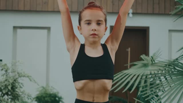 A Child Holding a Red Exercise Ball