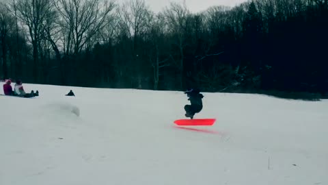 Kid red sled jump spins out