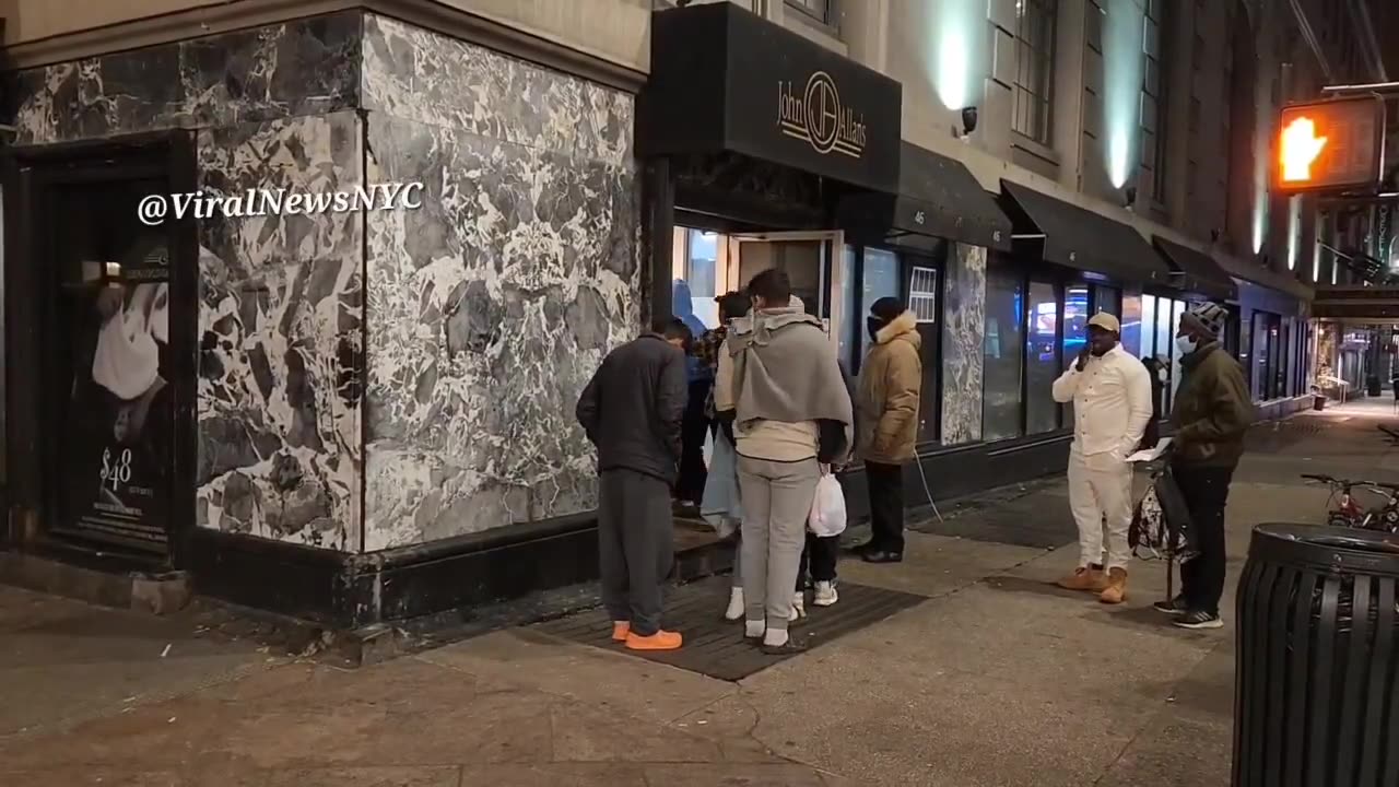 A massive wave of illegal immigrants head into the Roosevelt Hotel NYC in the freezing cold