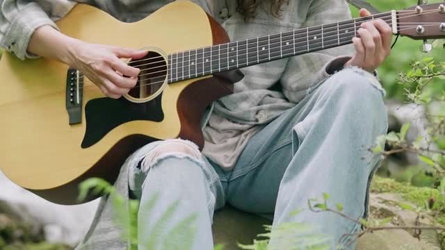 playing guitar in the forest