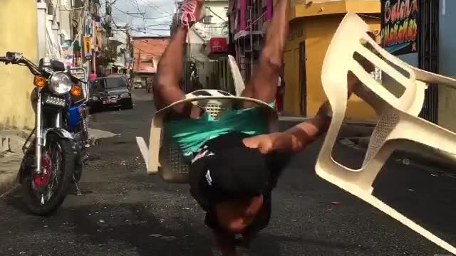 Check out this dude dancing on his hands with plastic chairs