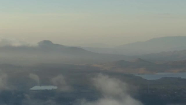 Aerial tour above a cloudy natural landscape