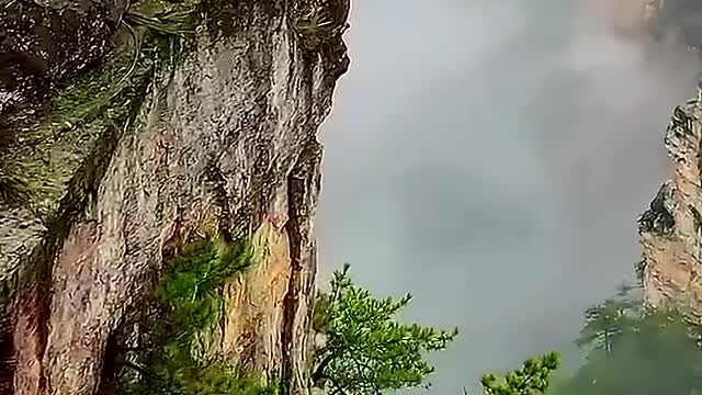 Mountain peaks tower into the sky.