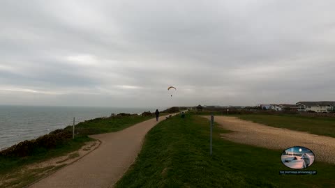 Milford in sea. Seaside with a hangglider over head