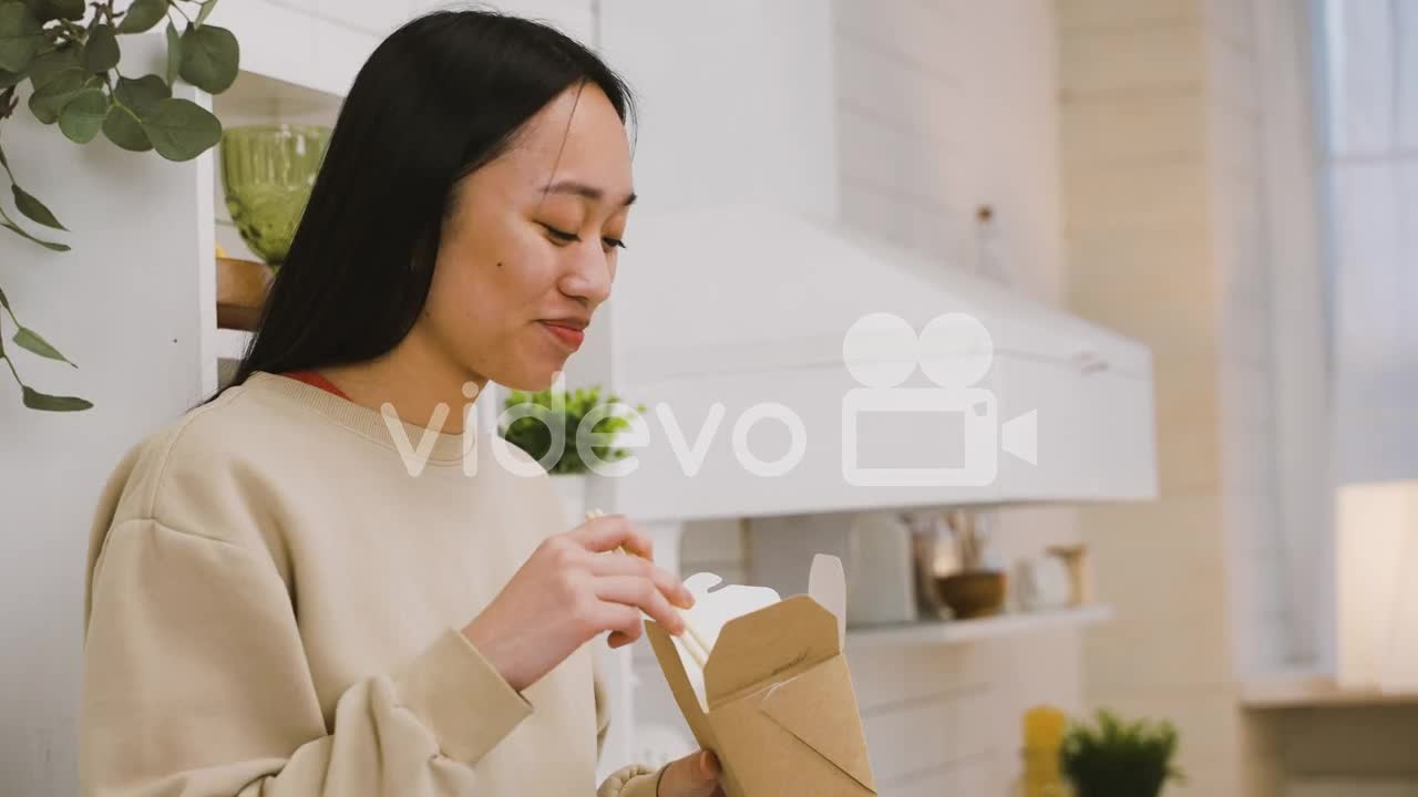 Happy Japanese Girl Eating Takeaway Ramen While Looking At The Camera And Smiling 2