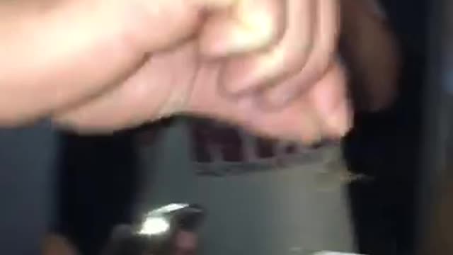 Guy white shirt drinks beer with spider inside