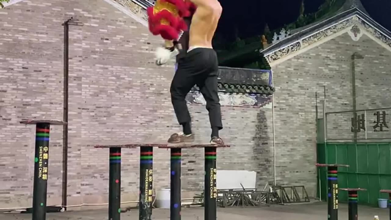 Practicing lion dance on the top platform