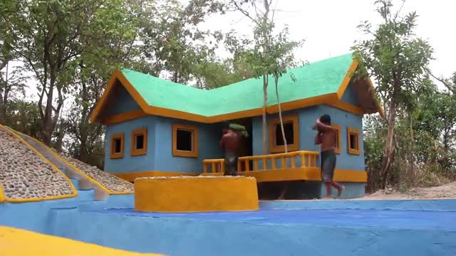 Look at this man building a beautiful house in the forest