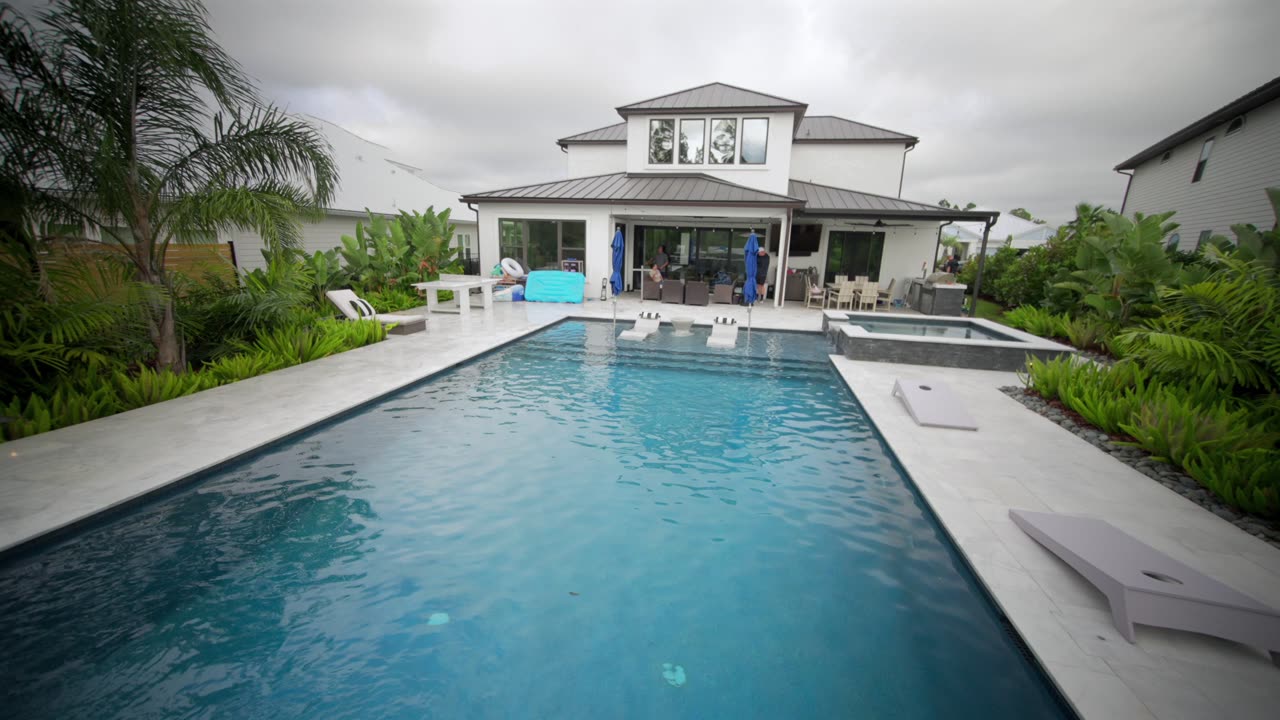 Dive into our poolside backyard palm tree paradise in the Beachwalk Community in St. Johns County