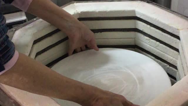 Unloading a porcelain bisque kiln.