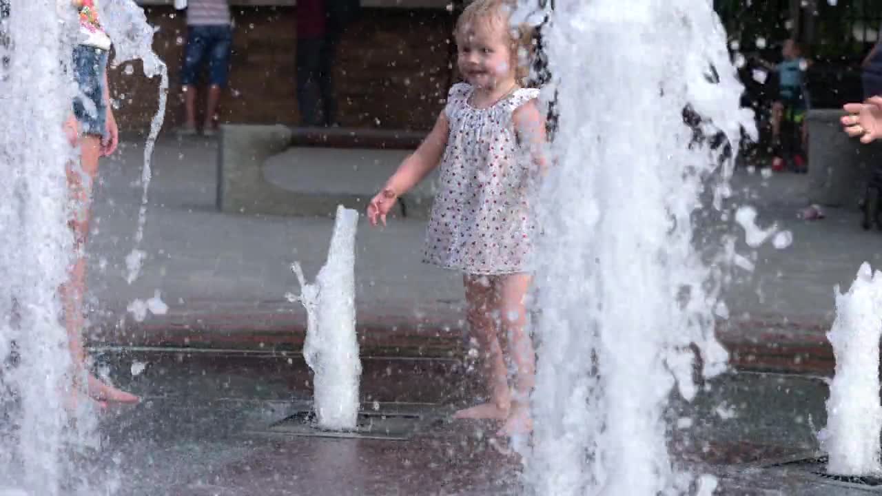 Take a look at how the baby is trying to catch the water