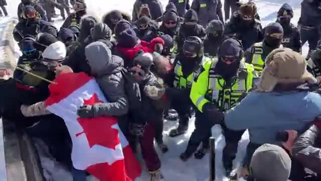 Protesters push back as police line moves forward