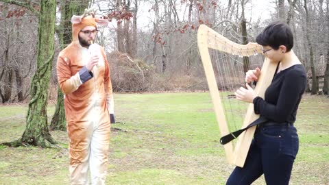 Girl Attracts Deer While Playing Harp in the Woods