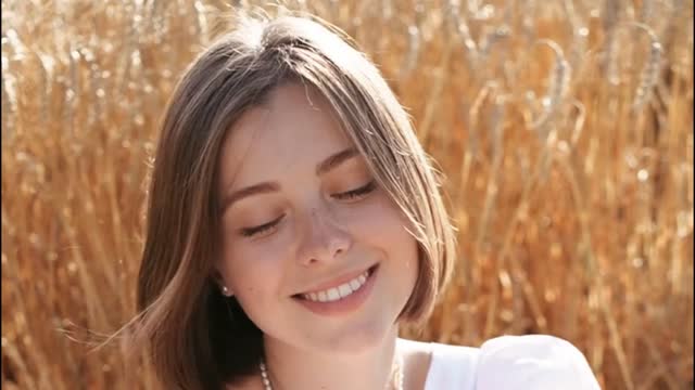 Beautiful Girl In Wheat Field At Sunset