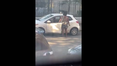 TGIF! Happy New York woman has a quick dance break by her car to celebrate the end of the week