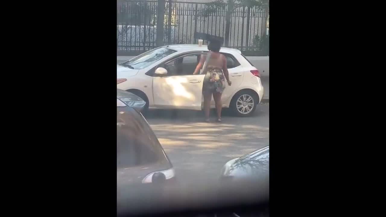 TGIF! Happy New York woman has a quick dance break by her car to celebrate the end of the week