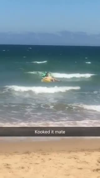 Guy floats in ocean on large pineapple inflatable toy