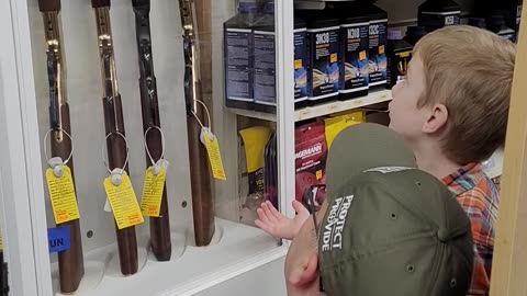 Caleb shopping for his Henry Golden Boy .22 rifle