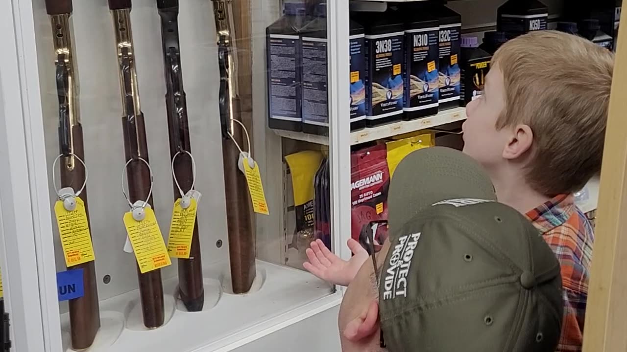 Caleb shopping for his Henry Golden Boy .22 rifle