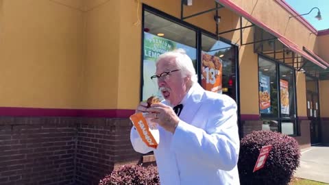 Unreal Colonel Sanders eats a Popeye's Chicken Sandwich