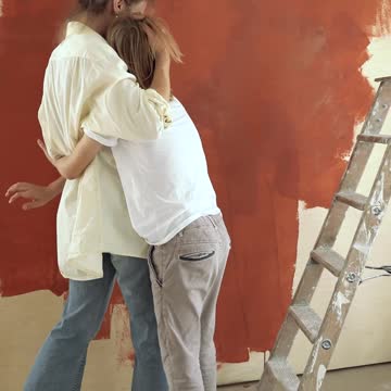 Adult and Child Painting a Wall