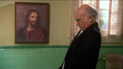 Jewish Comedian Larry David pisses on picture of Jesus (A Talmudic Jewish inside joke)