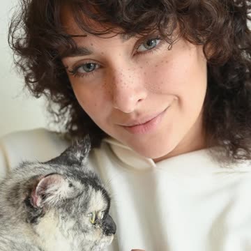 Woman cuddling her cat 4K