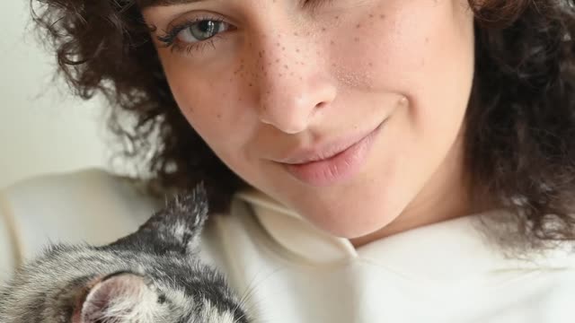 Woman cuddling her cat 4K