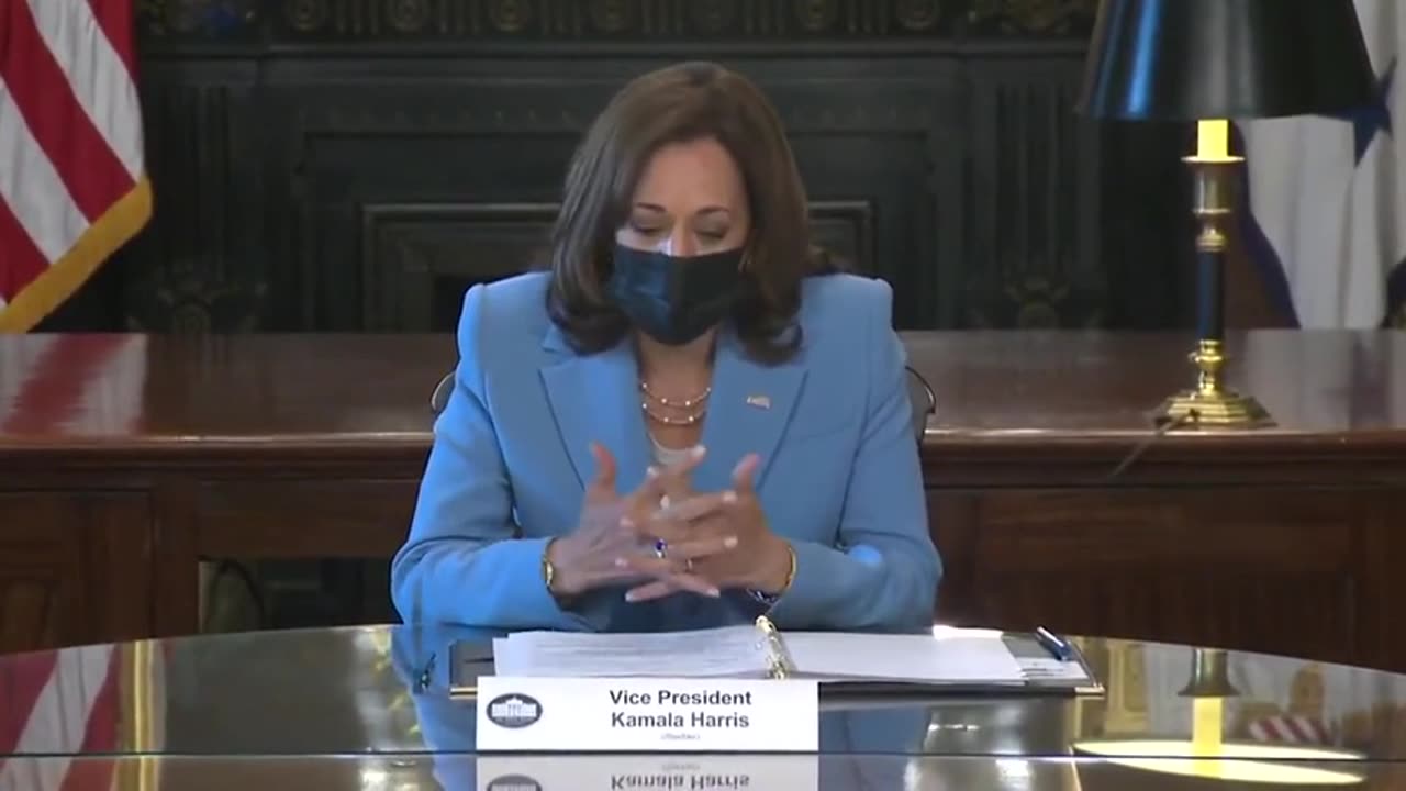 I am Kamala Harris, my pronouns are she and her, and I am a woman sitting at the table