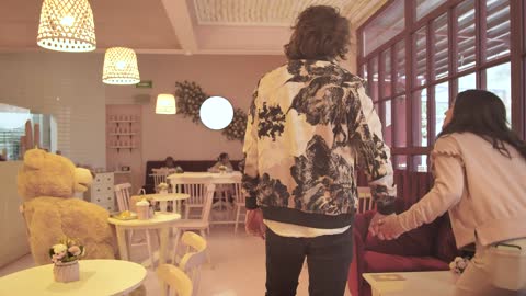 Couple walking into a romantic cafe on a date