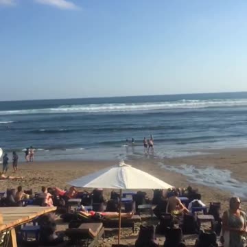 Two guys on sand beach fighting