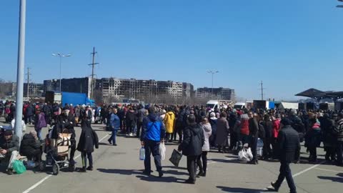 Russian soldiers distribute humanitarian aid and food to civilians in one of the shopping centers of