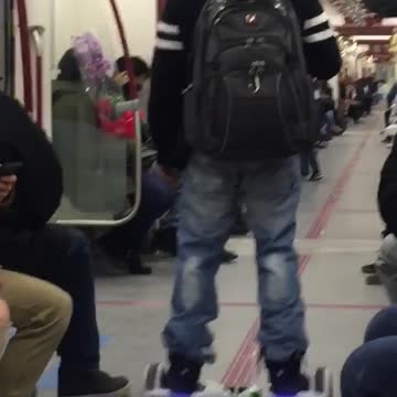 Man hover boards through subway