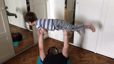 Father and child exercising at home