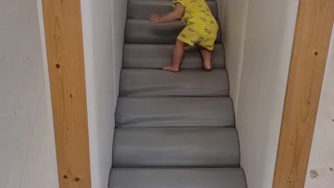 A baby climbing stairs