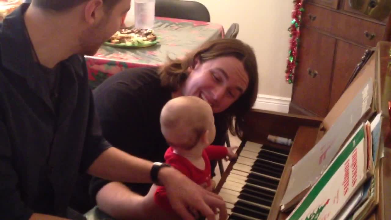 baby is mesmerized by piano playing