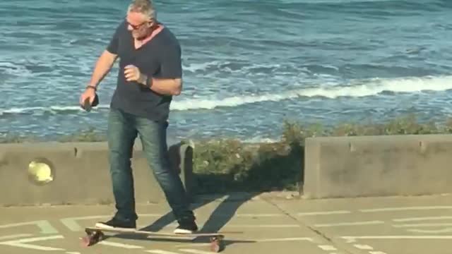 Commentary of dad grey white hair on phone riding by on longboard