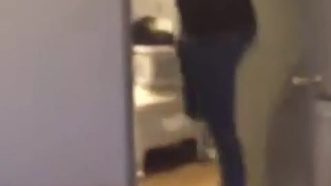 Teen in black hoodie jumps and hits head on doorway