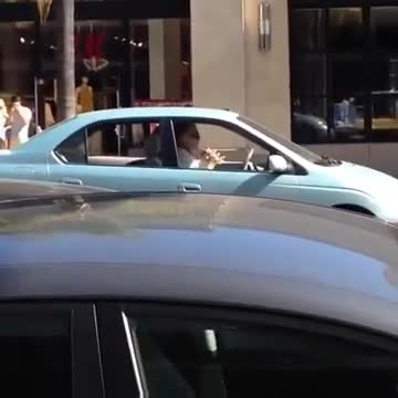 Lexy playing the recorder in her car