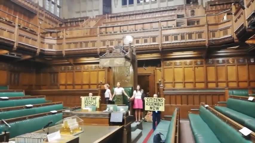 Extinction Rebellion activists glue themselves to speaker's chair in House of Commons