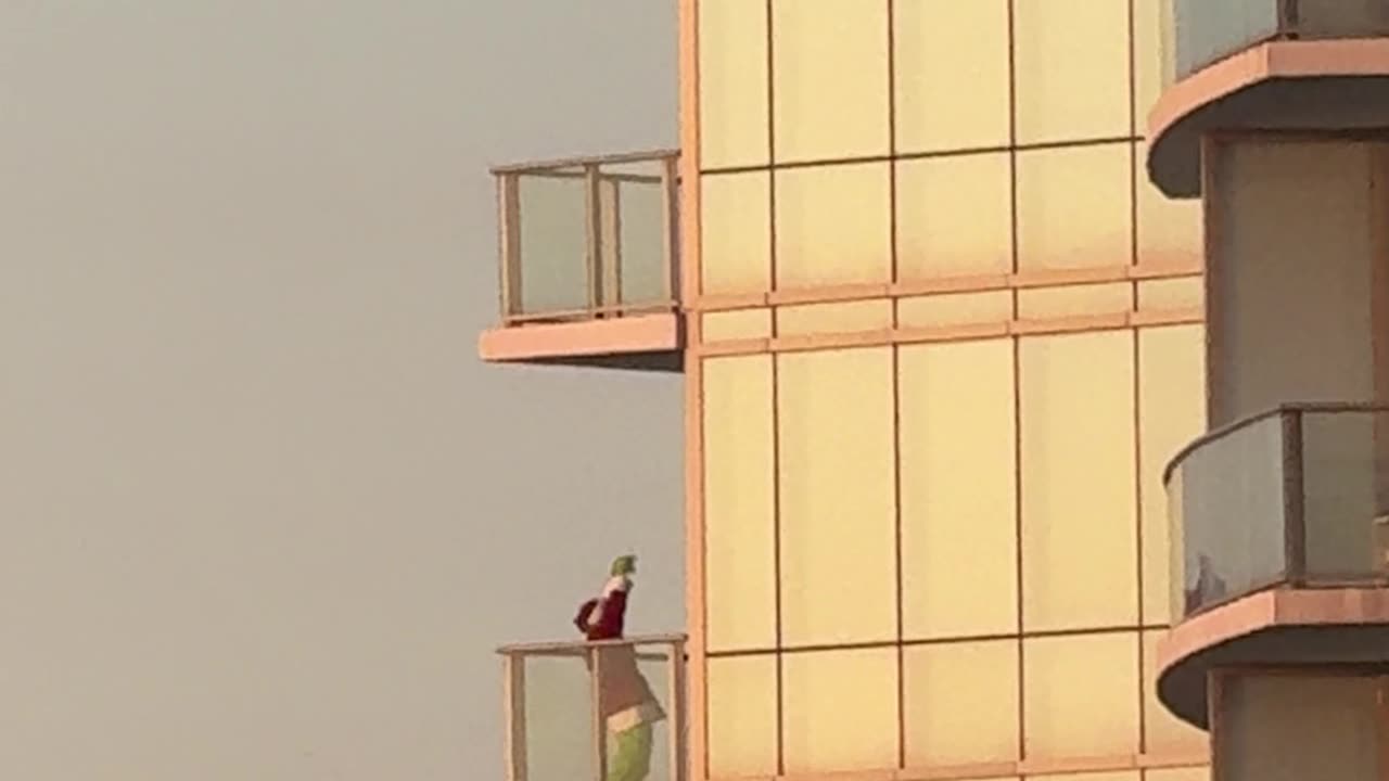 Grinch Dances on High-Rise Balcony